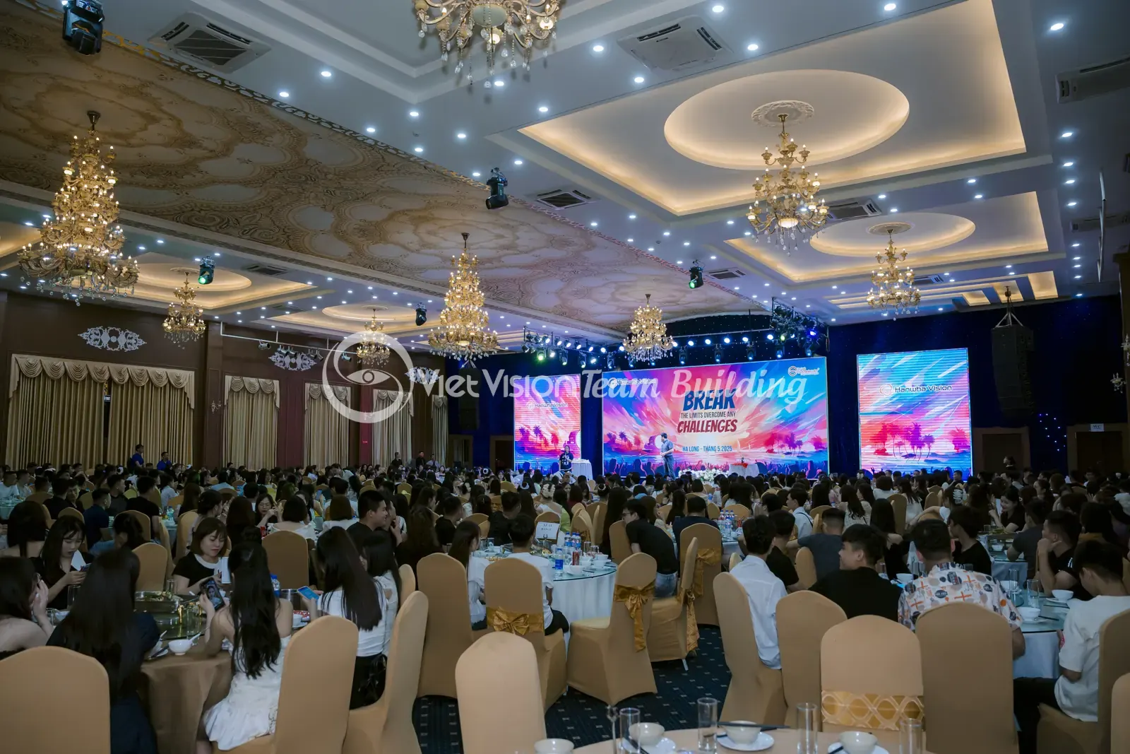 Khách ngồi theo bàn trong phòng tiệc doanh nghiệp